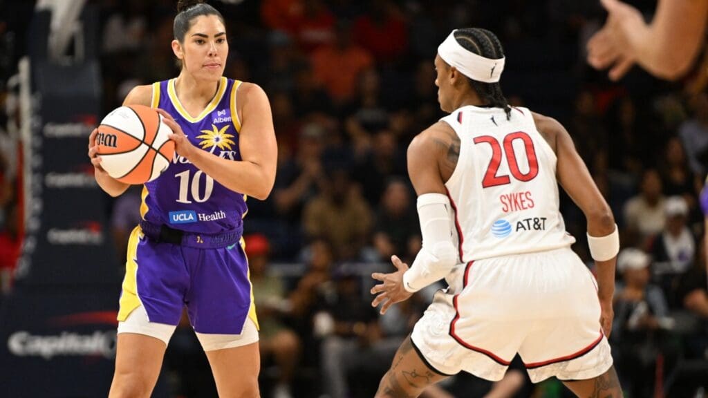 Jul 22, 2025; Washington, District of Columbia, USA; Los Angeles Sparks guard Kelsey Plum (10) looks to pass the ball in front of Washington Mystics guard Brittney Sykes (20) during the first quarter at CareFirst Arena.