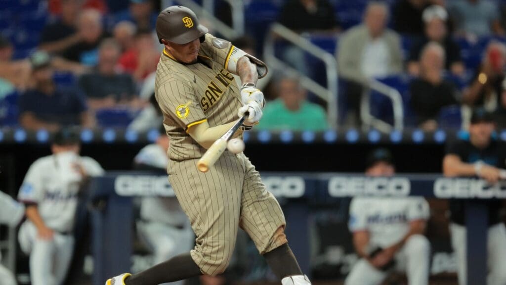 Jul 23, 2025; Miami, Florida, USA; San Diego Padres third baseman Manny Machado (13) hits a double against the Miami Marlins during the seventh inning at loanDepot Park. Mandatory Credit: