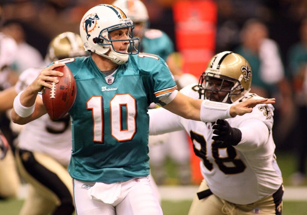 September 3, 2009; New Orleans, LA, USA; Miami Dolphins quarterback Chad Pennington (10) scrambles under pressure from New Orleans Saints defensive tackle Sedrick Ellis (98) during the 1st half of their preseason game at the Louisiana Superdome.