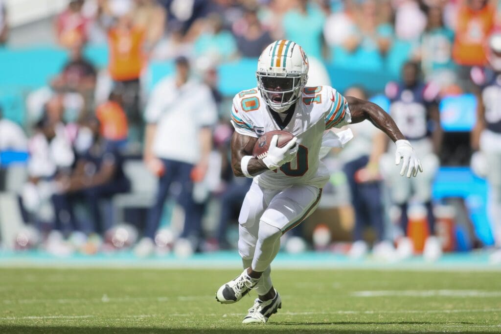 Oct 29, 2023; Miami Gardens, Florida, USA; Miami Dolphins wide receiver Tyreek Hill (10) runs with the football against the New England Patriots during the second quarter at Hard Rock Stadium.