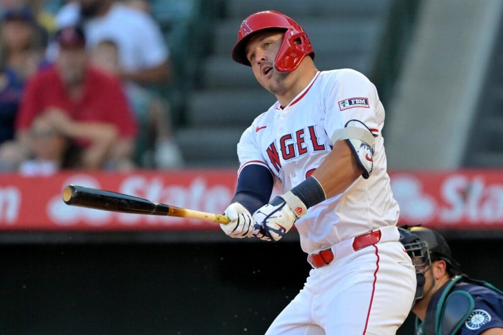 Jul 24, 2025; Anaheim, California, USA; Los Angeles Angels right fielder Mike Trout (27) singles in the first inning against the Seattle Mariners at Angel Stadium.