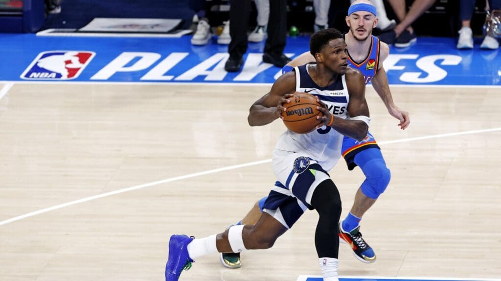 May 28, 2025; Oklahoma City, Oklahoma, USA; Minnesota Timberwolves guard Anthony Edwards (5) drives to the basket against Oklahoma City Thunder guard Alex Caruso (9) during the third quarter in game five of the western conference finals for the 2025 NBA Playoffs at Paycom Center.
