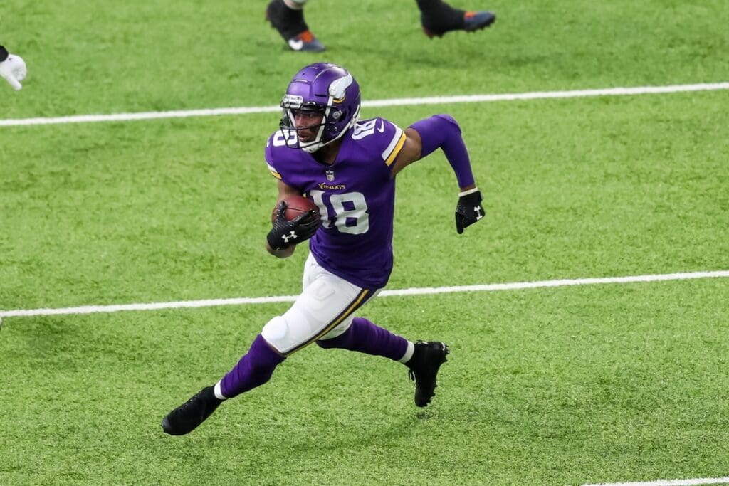 Dec 20, 2020; Minneapolis, Minnesota, USA; Minnesota Vikings wide receiver Justin Jefferson (18) runs with the ball during the third quarter against the Chicago Bears at U.S. Bank Stadium.