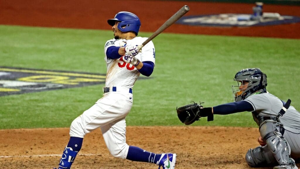 Oct 27, 2020; Arlington, Texas, USA; Los Angeles Dodgers right fielder Mookie Betts (50) hits a home run during the eighth inning against the Tampa Bay Rays during game six of the 2020 World Series at Globe Life Field.