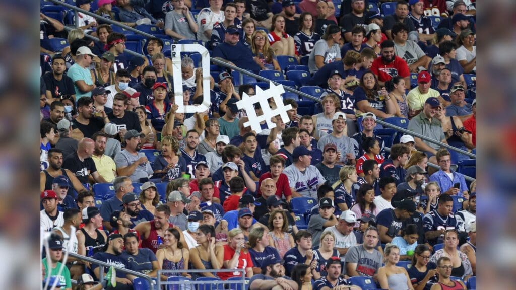 Aug 12, 2021; Foxborough, Massachusetts, USA; New England Patriots fans hold up a defense sign during the second half against the Washington Football Team at Gillette Stadium. 