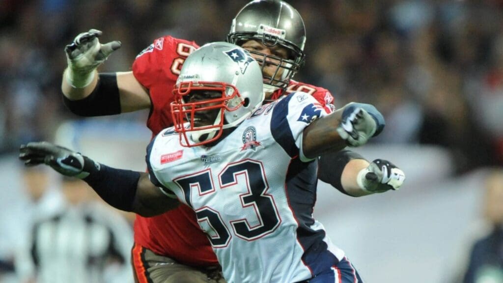 Oct 25, 2009; London, ENGLAND; New England Patriots defensive end Derrick Burgess (53) tries to get past Tampa Bay Buccaneers tackle Jeremy Trueblood (65) during the regular season NFL International Series game at Wembley Stadium. The Patriots defeated the Buccaneers 35-7.