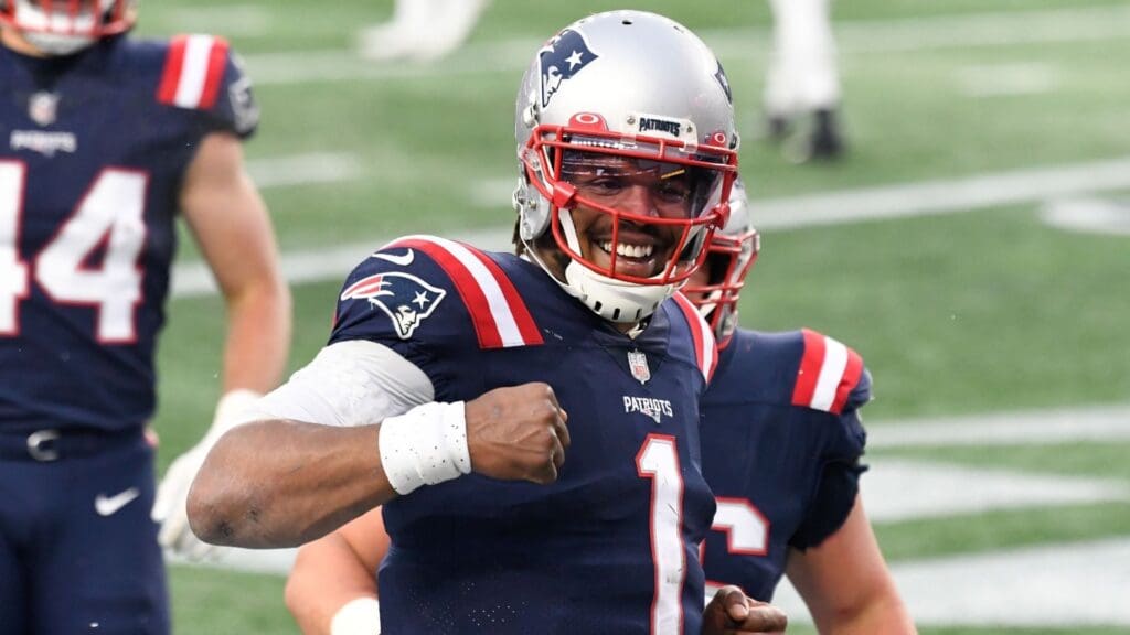 Jan 3, 2021; Foxborough, Massachusetts, USA; New England Patriots quarterback Cam Newton (1) celebrates after scoring a touchdown against the New York Jets during the third quarter at Gillette Stadium.