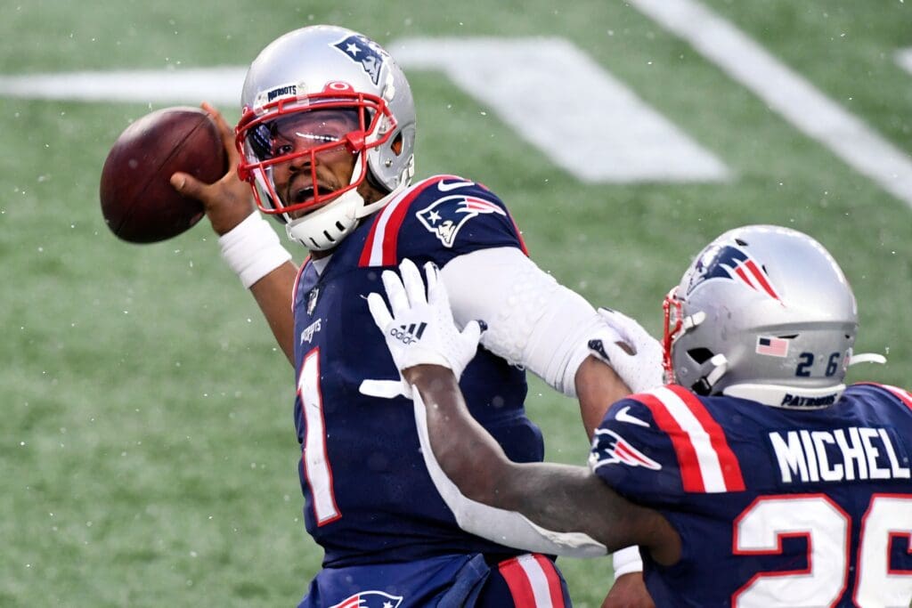 Jan 3, 2021; Foxborough, Massachusetts, USA; New England Patriots quarterback Cam Newton (1) celebrates with running back Sony Michel (26) after scoring a touchdown against the New York Jets during the forth quarter at Gillette Stadium.