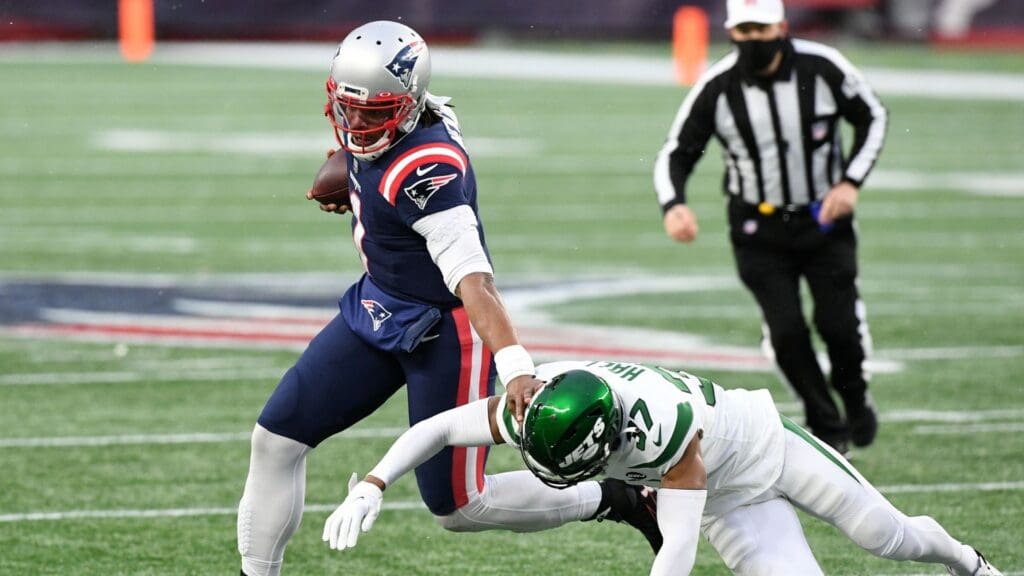 Jan 3, 2021; Foxborough, Massachusetts, USA; New England Patriots quarterback Cam Newton (1) runs against New York Jets cornerback Bryce Hall (37) during the third quarter at Gillette Stadium.
