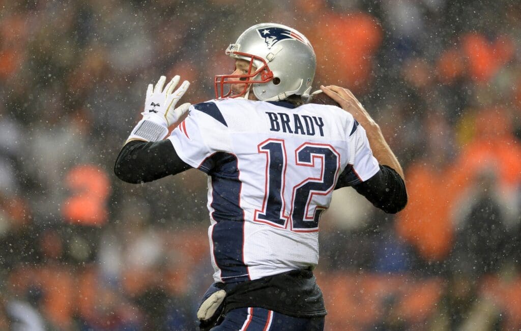 Nov 29, 2015; Denver, CO, USA; New England Patriots quarterback Tom Brady (12) prepares to pass the football in the second quarter against the Denver Broncos at Sports Authority Field at Mile High.