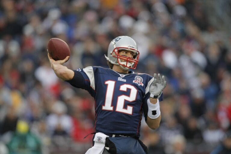 Dec 13, 2009; Foxborough, MA, USA; New England Patriots quarterback Tom Brady (12) throws a pass against the Carolina Panthers during the first quarter at Gillette Stadium.