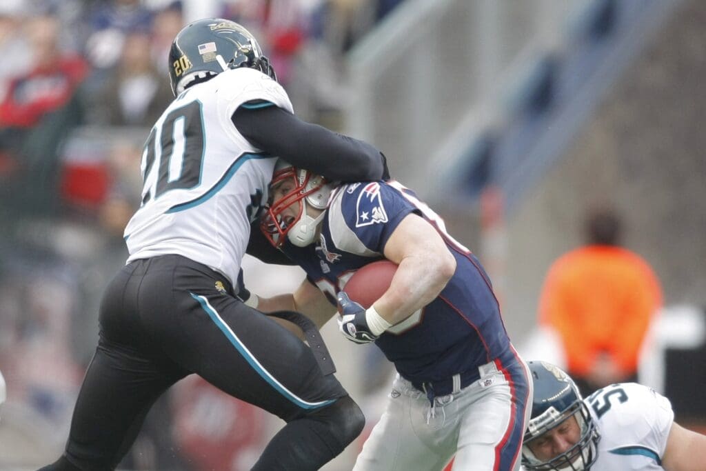 Dec 27, 2009; Foxborough, MA, USA; Jacksonville Jaguars safety Anthony Smith (20) attempts to stop New England Patriots wide receiver Wes Welker (83) during a second-quarter play at Gillette Stadium.