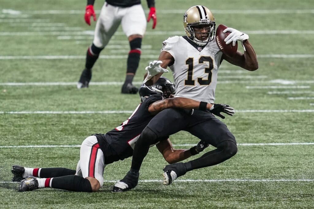 Dec 6, 2020; Atlanta, Georgia, USA; New Orleans Saints wide receiver Michael Thomas (13) holds on to the ball while being tackled by Atlanta Falcons cornerback A.J. Terrell (24) during the second half at Mercedes-Benz Stadium. 
