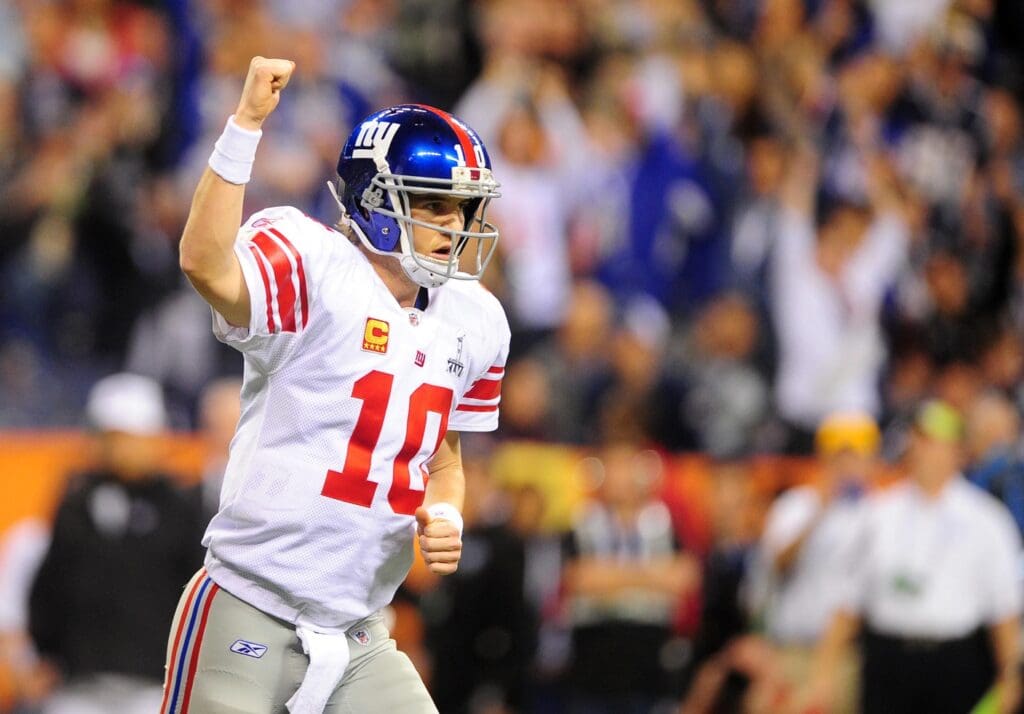 Feb 5, 2012; Indianapolis, IN, USA; New York Giants quarterback Eli Manning (10) reacts after throwing a touchdown pass during the first half of Super Bowl XLVI against the New England Patriots at Lucas Oil Stadium.