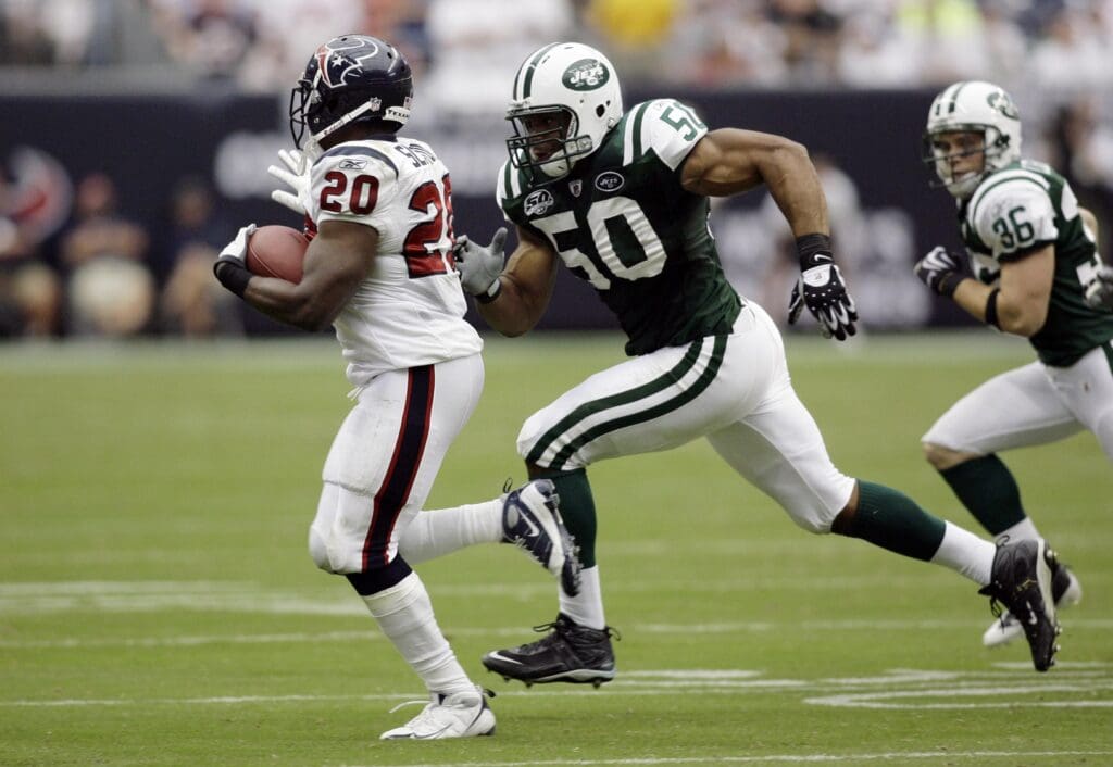 Sept 13, 2009; Houston, TX, USA; New York Jets linebacker Vernon Gholston (50) chases Houston Texans running back Steve Slaton (20) in the third quarter at Reliant Stadium. The Jets defeated the Texans 24-7. 