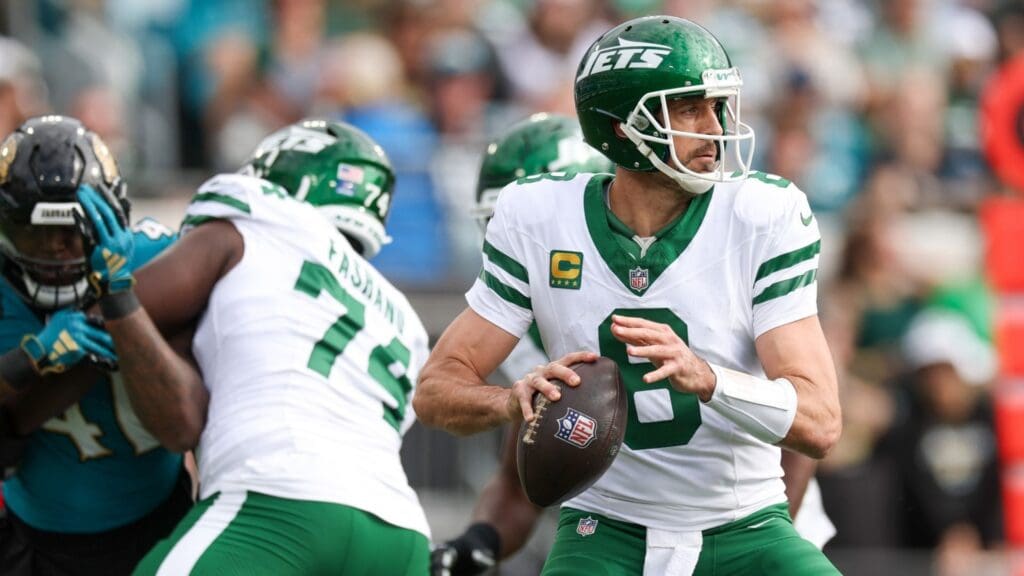 Dec 15, 2024; Jacksonville, Florida, USA; New York Jets quarterback Aaron Rodgers (8) drops back to pass against the Jacksonville Jaguars in the first quarter at EverBank Stadium.