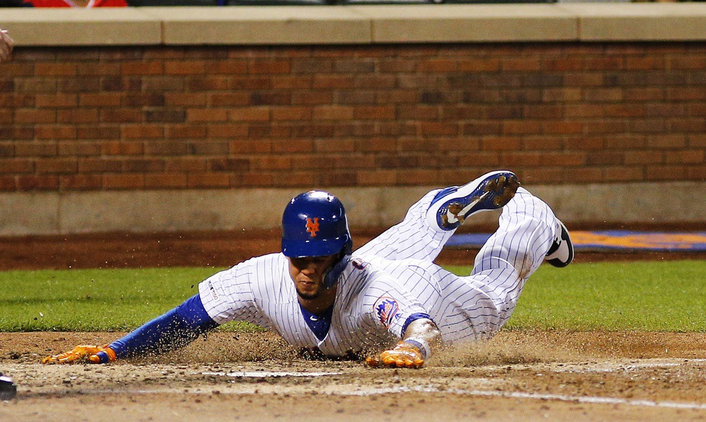 Jun 15, 2019; New York City, NY, USA; New York Mets center fielder Carlos Gomez (91) slides home safely on an RBI single by New York Mets right fielder Michael Conforto (not pictured) against the St. Louis Cardinals during the sixth inning at Citi Field.