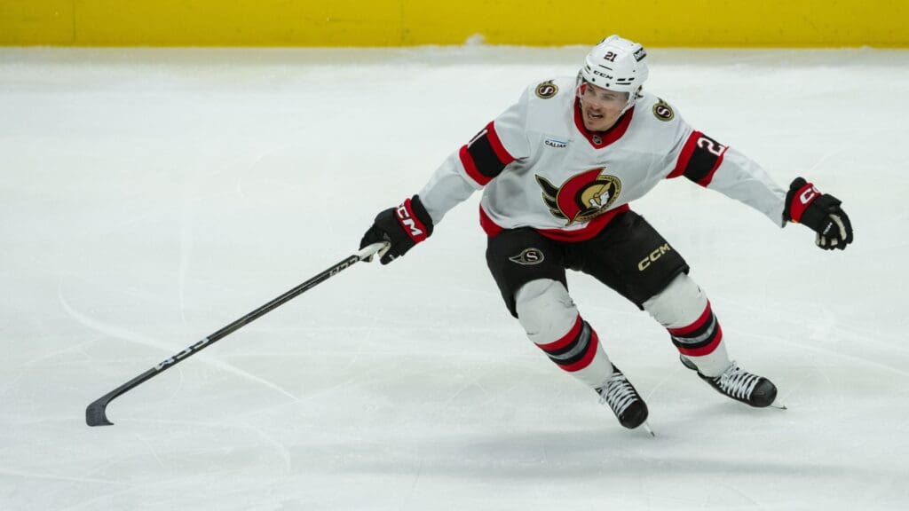 Jan 9, 2025; Ottawa, Ontario, CAN; Ottawa Senators center Nick Cousins (21) reaches for the puck in the third period against the Buffalo Sabres at the Canadian Tire Centre.