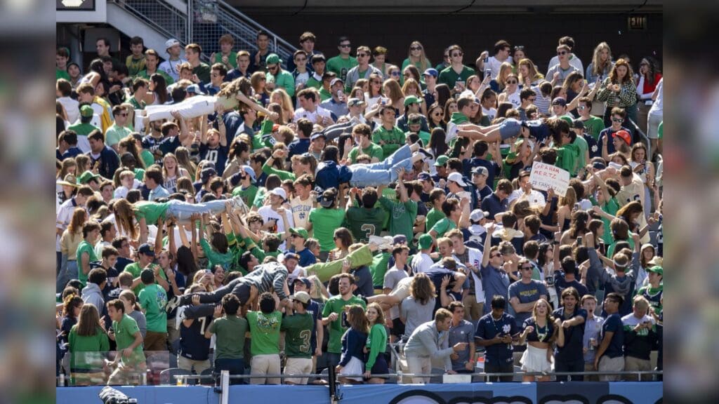 Sep 25, 2021; Chicago, Illinois, USA; Notre Dame Fighting Irish fans celebrate a touchdown by lifting each up during the first half against the Wisconsin Badgers at Soldier Field.