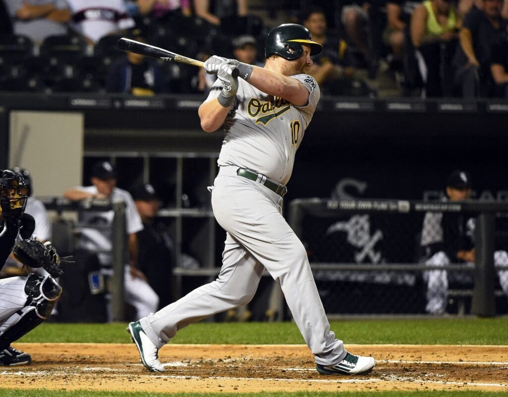 Sep 10, 2014; Chicago, IL, USA; Oakland Athletics designated hitter Adam Dunn (10) hits a RBI single against the Chicago White Sox during the fifth inning at U.S Cellular Field.