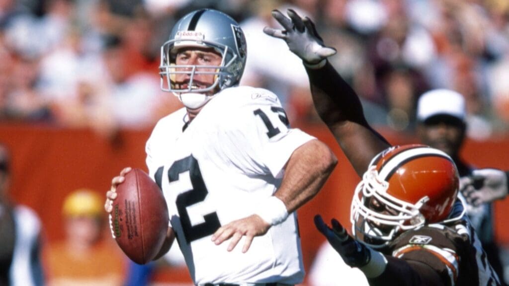 Oct 12, 2003; Cleveland, OH, USA; Oakland Raiders quarterback Rich Gannon (12) scrambles in the pocket against Cleveland Browns defensive end Courtney Brown (92) at Cleveland Browns Stadium. The Browns beat the Raiders 13-7.