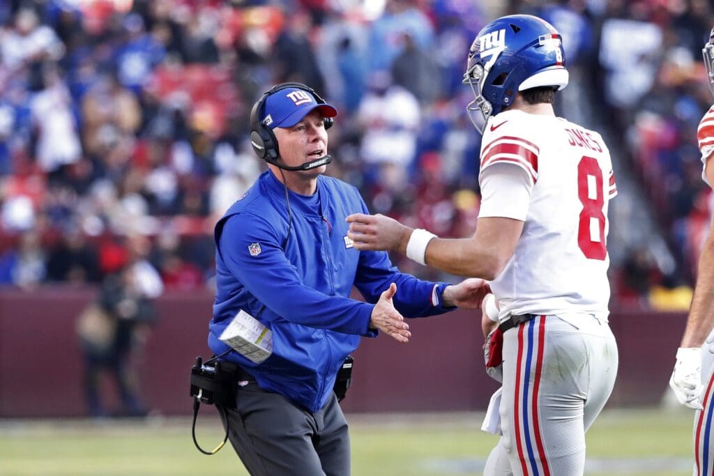 Dec 22, 2019; Landover, Maryland, USA; New York Giants quarterback Daniel Jones (8) is congratulated by Giants head coach Pat Shurmur after throwing a touchdown pass against the Washington Redskins in the first quarter at FedExField.