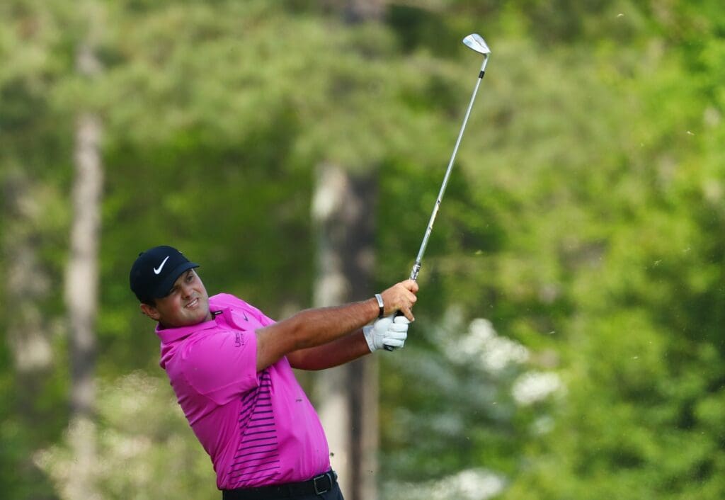 Apr 8, 2018; Augusta, GA, USA; Patrick Reed hits his tee shot on the 12th hole during the final round of the Masters golf tournament at Augusta National Golf Club.
