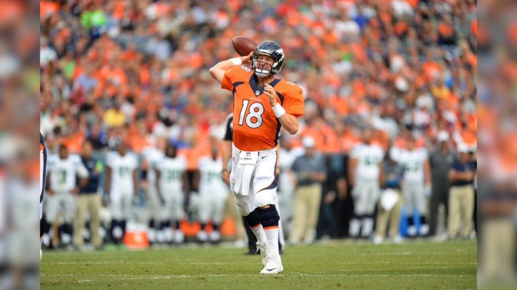 Aug 7, 2014; Denver, CO, USA; Denver Broncos quarterback Peyton Manning (18) prepares to pass in the first quarter against the Seattle Seahawks at Sports Authority Field at Mile High.
