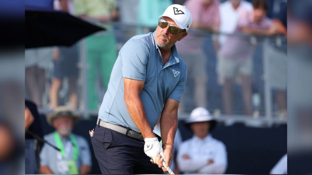 Jun 12, 2025; Oakmont, Pennsylvania, USA; Phil Mickelson prepares to play his shot from the tenth tee during the first round of the U.S. Open golf tournament.
