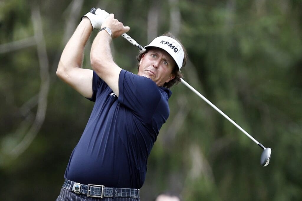 Aug 11, 2013; Rochester, NY, USA; Phil Mickelson tees off on the 16th hole during the final round of the 95th PGA Championship at Oak Hill Country Club.