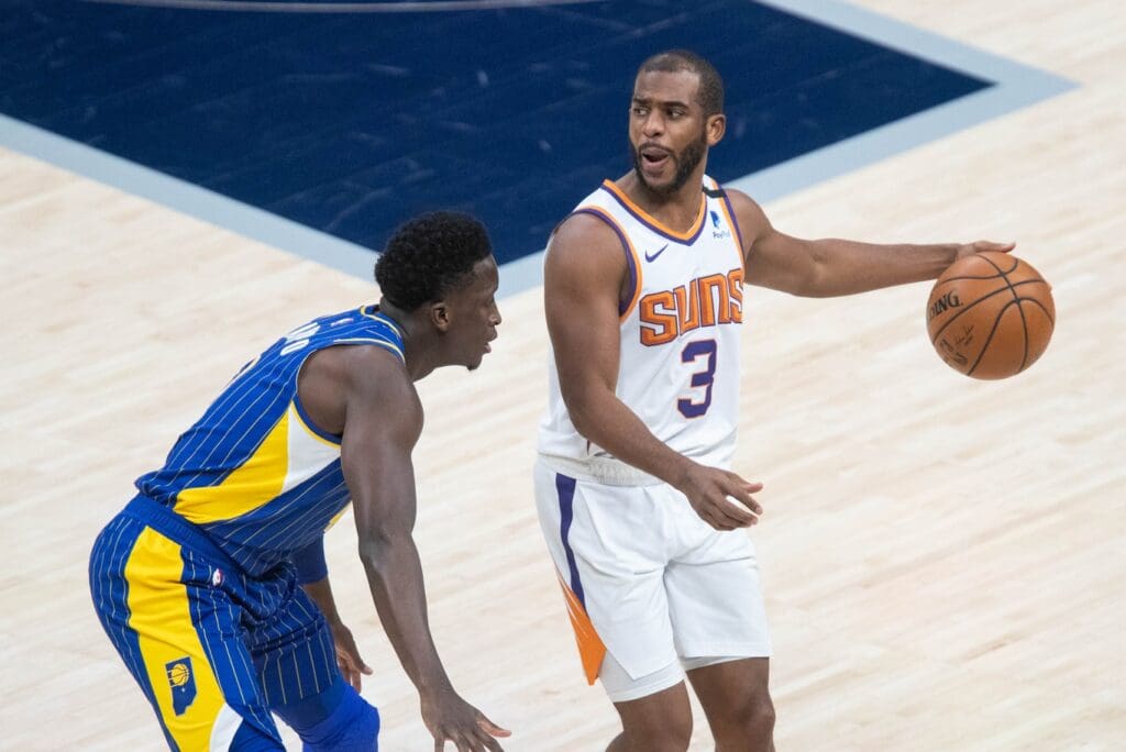 Jan 9, 2021; Indianapolis, Indiana, USA; Phoenix Suns guard Chris Paul (3) dribbles the ball while Indiana Pacers guard Victor Oladipo (4) defends in the first quarter at Bankers Life Fieldhouse.