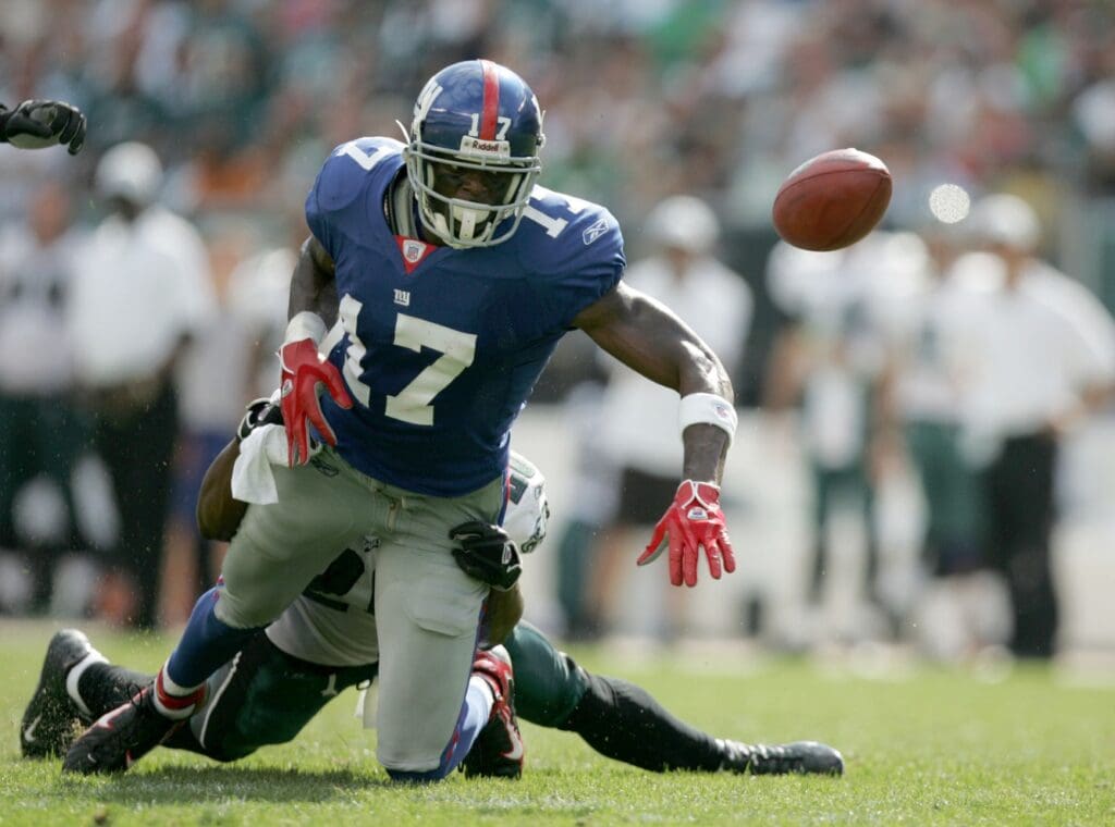 Sep 17, 2006; Philadelphia, PA, USA; New York Giants wide receiver (17) Plaxico Burress fumbles the ball after being tackled by Philadelphia Eagles safety (20) Brian Dawkins at Lincoln Financial Field in Philadelphia.