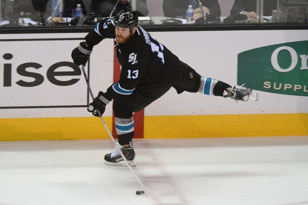 Apr 30, 2014; San Jose, CA, USA; San Jose Sharks left wing Raffi Torres (13) passes the puck against the Los Angeles Kings during the first period in game seven of the first round of the 2014 Stanley Cup Playoffs at SAP Center at San Jose. The Kings defeated the Sharks 5-1.