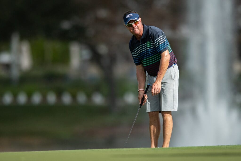 Dec 16, 2021; Orlando, Florida, USA; Rich Beem lines up his shot on the 18th green during a pro-am round of the PNC Championship golf tournament at Grande Lakes Orlando Course.
