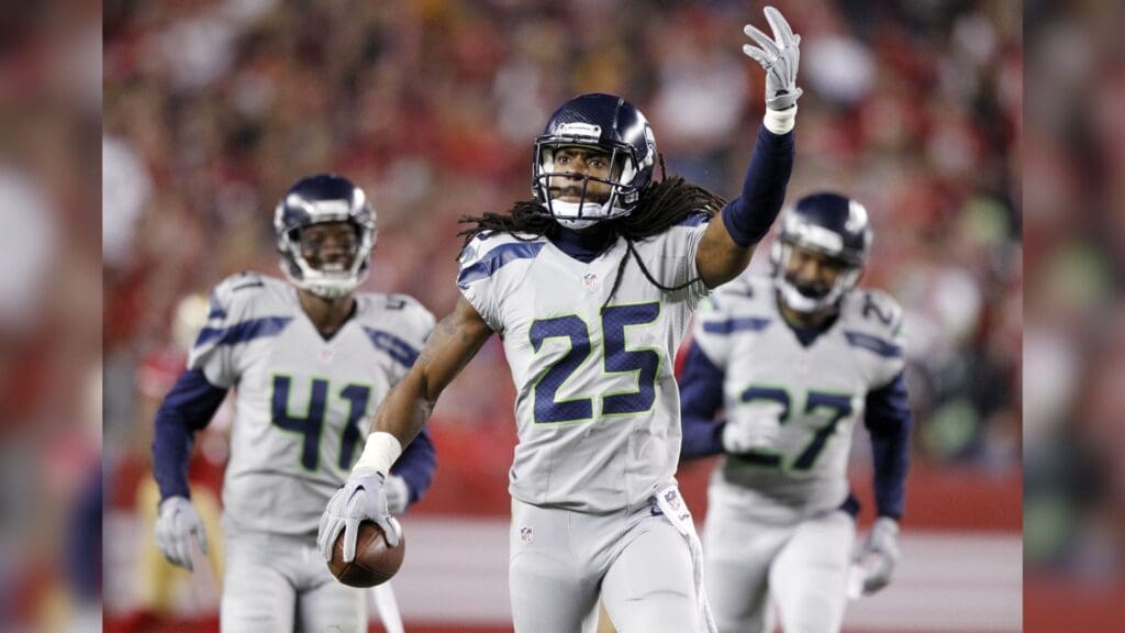 Nov 27, 2014; Santa Clara, CA, USA; Seattle Seahawks cornerback Richard Sherman (25) reacts after recording an interception against the San Francisco 49ers in the first quarter at Levi's Stadium.
