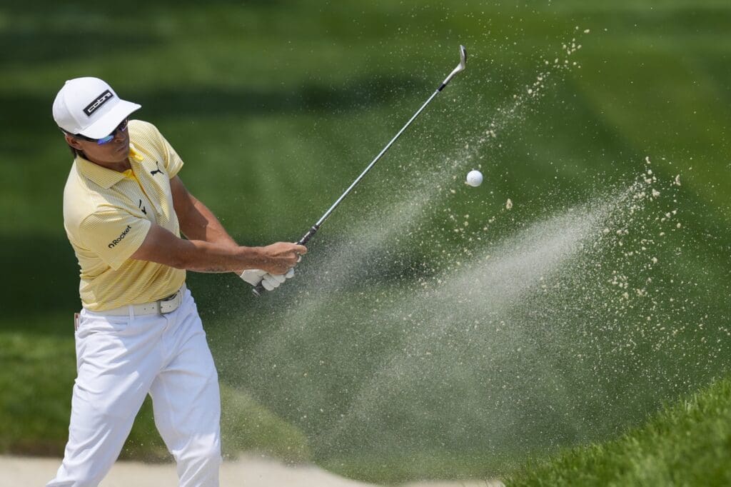 Jun 1, 2025; Dublin, Ohio, USA; Rickie Fowler plays his shot from a bunker on the eighth hole during the final round of the Memorial Tournament presented by Workday golf tournament.
