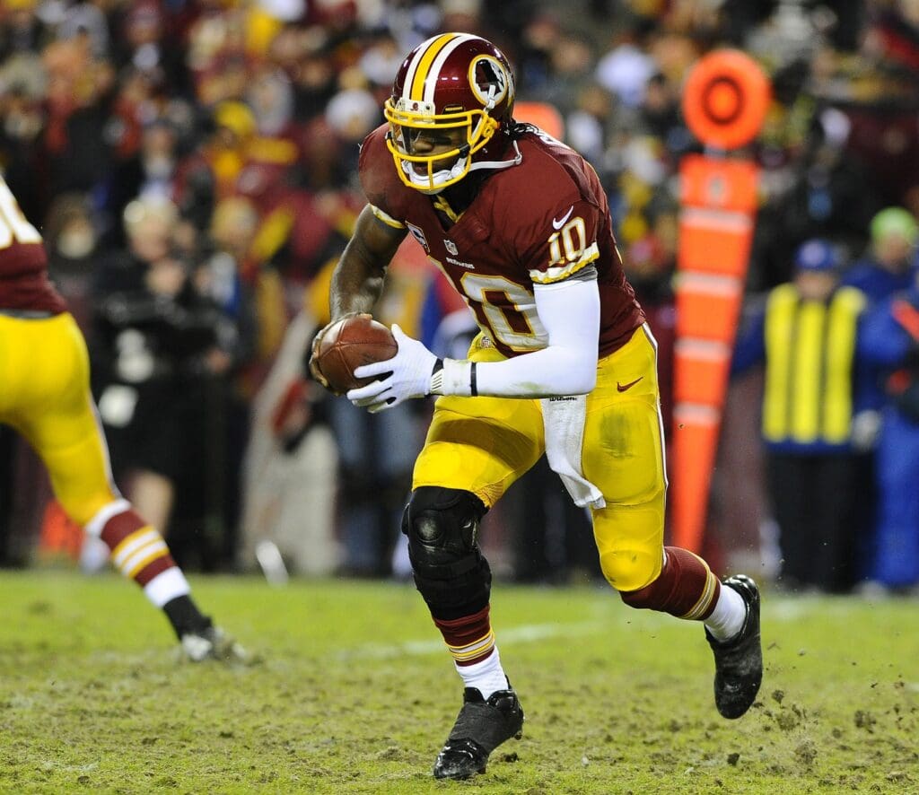 Dec 30, 2012; Landover, MD, USA; Washington Redskins quarterback Robert Griffin III (10) runs for a first down during the second half against the Dallas Cowboys at FedEX Field.