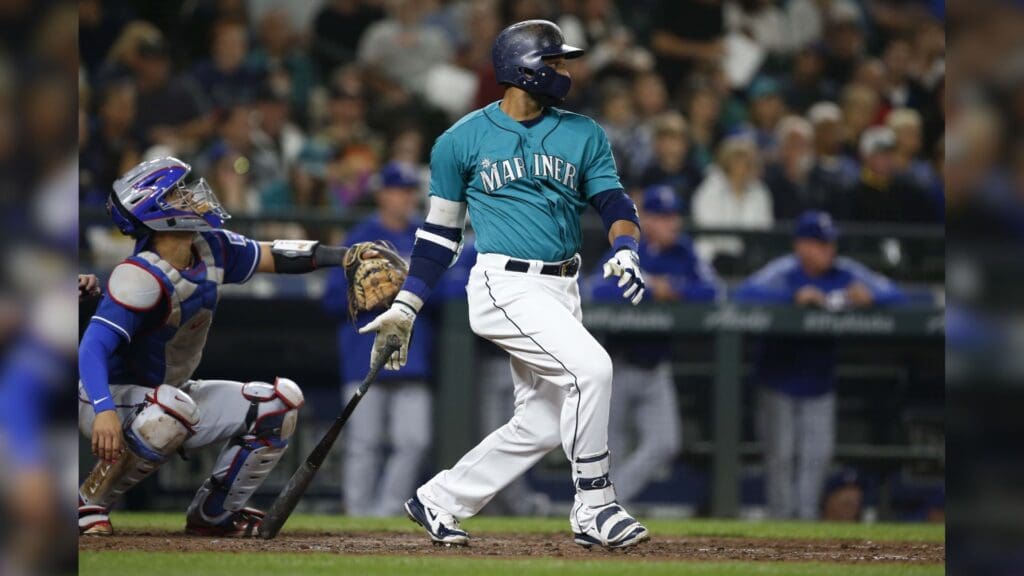 Sep 28, 2018; Seattle, WA, USA; Seattle Mariners second baseman Robinson Cano (22) follows through on an RBI single against the Texas Rangers during the third inning at Safeco Field.