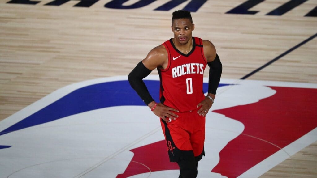 Aug 11, 2020; Lake Buena Vista, Florida, USA; Houston Rockets guard Russell Westbrook (0) looks on from center court during the first half of a NBA basketball game against the San Antonio Spurs at The Field House. 