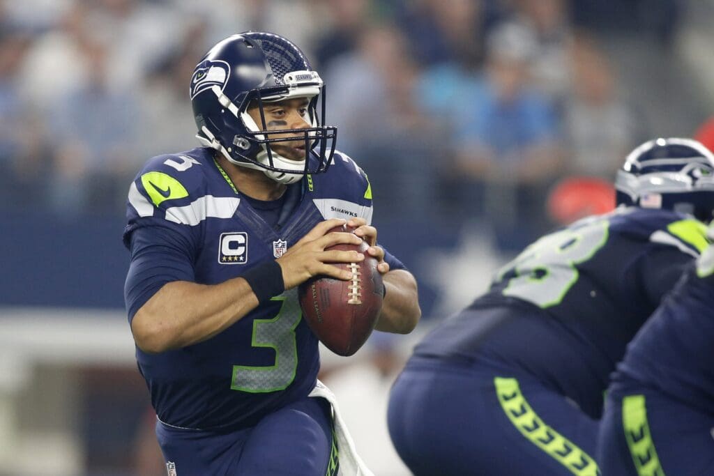 Nov 1, 2015; Arlington, TX, USA; Seattle Seahawks quarterback Russell Wilson (3) rolls out to throw a pass in the second quarter against the Dallas Cowboys at AT&T Stadium.
