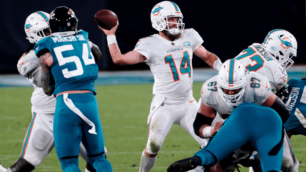 Sep 24, 2020; Jacksonville, Florida, USA; Miami Dolphins quarterback Ryan Fitzpatrick (14) drops back to pass the ball against the Jacksonville Jaguars during the first half at TIAA Bank Field.