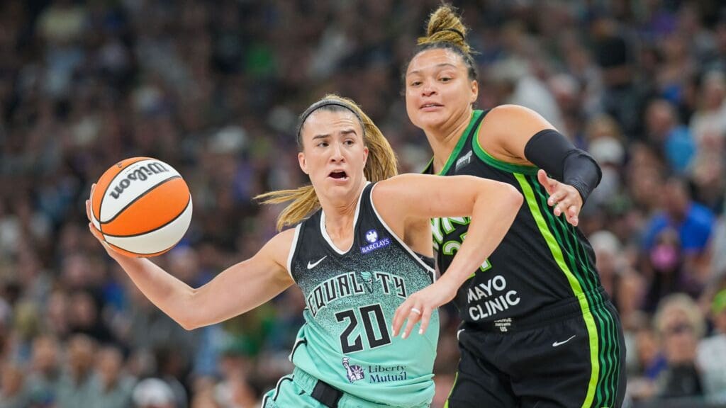 Jul 30, 2025; Minneapolis, Minnesota, USA; New York Liberty guard Sabrina Ionescu (20) dribbles against the Minnesota Lynx guard Kayla McBride (21) in the third quarter at Target Center.