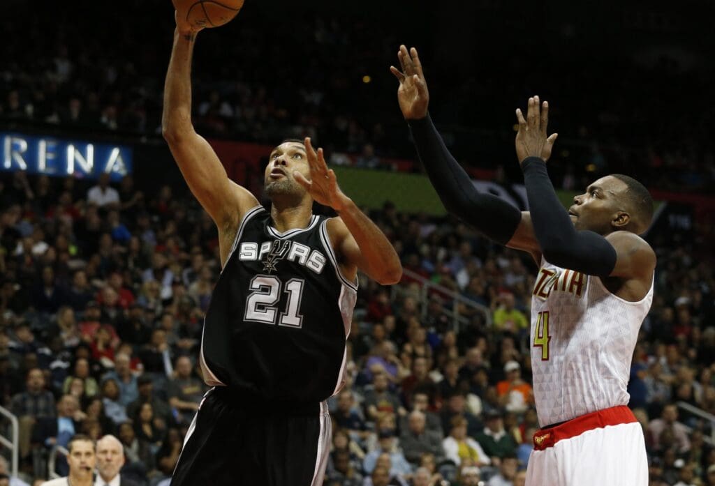 Dec 12, 2015; Atlanta, GA, USA; San Antonio Spurs center Tim Duncan (21) attempts a shot against Atlanta Hawks forward Paul Millsap (4) in the third quarter at Philips Arena. The Spurs defeated the Hawks 103-78.
