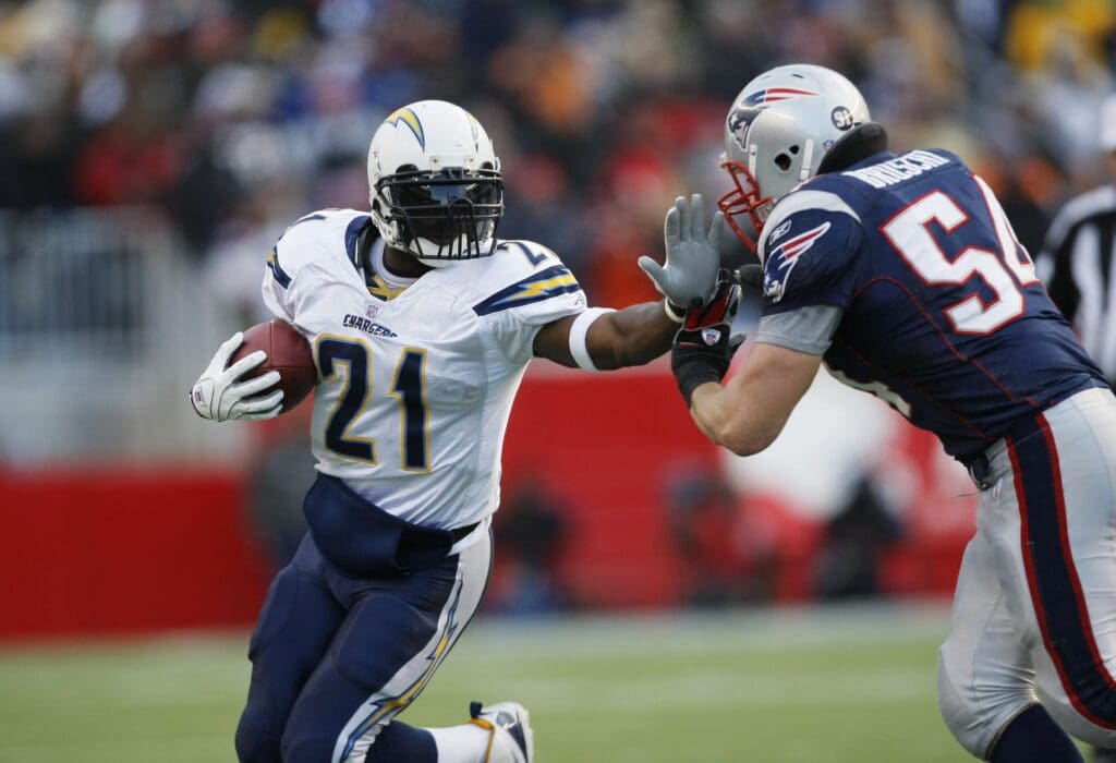 Jan 20, 2007; Foxborough, MA, USA; San Diego Chargers running back LaDainian Tomlinson (21) stiff-arms New England Patriots linebacker Tedy Bruschi (54) in the first quarter during the AFC Championship game at Gillette Stadium.