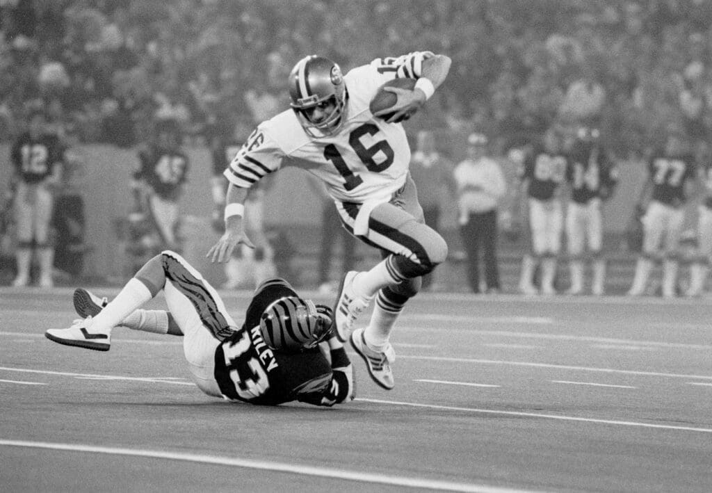 Jan 24, 1982; Detroit, MI, USA; FILE PHOTO; San Francisco 49ers quarterback (16) Joe Montana eludes Cincinnati Bengals defensive back (13) Ken Riley during Super Bowl XVI at the Silverdome. The 49ers defeated the Bengals to earn their first Super Bowl title 26-21.