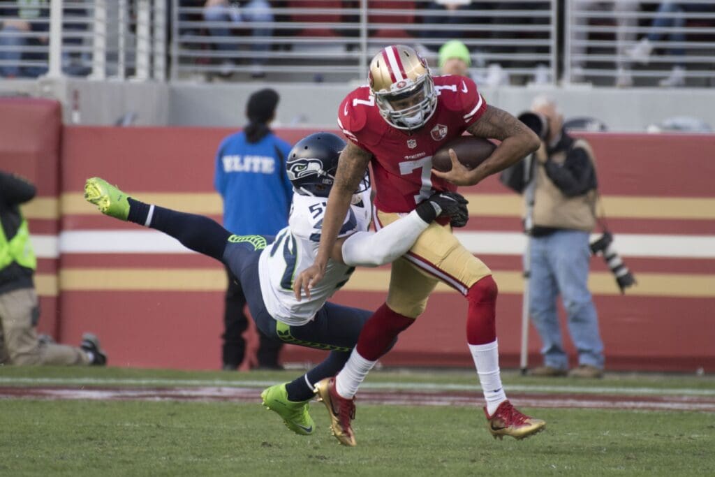 January 1, 2017; Santa Clara, CA, USA; San Francisco 49ers quarterback Colin Kaepernick (7) runs past Seattle Seahawks middle linebacker Bobby Wagner (54) during the second quarter at Levi's Stadium.