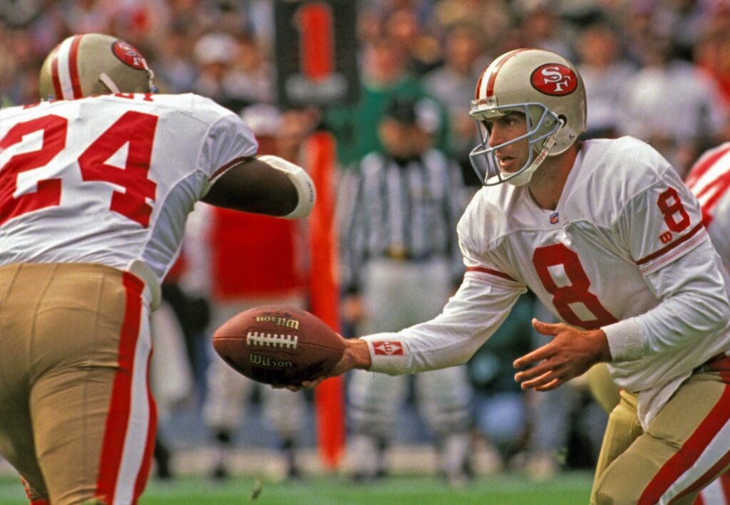 Nov 3, 1991; Atlanta, GA, USA; FILE PHOTO; San Francisco 49ers quarterback Steve Young (8) hands the ball off to Harry Sydney (24) against the Atlanta Falcons at Atlanta-Fulton County Stadium.