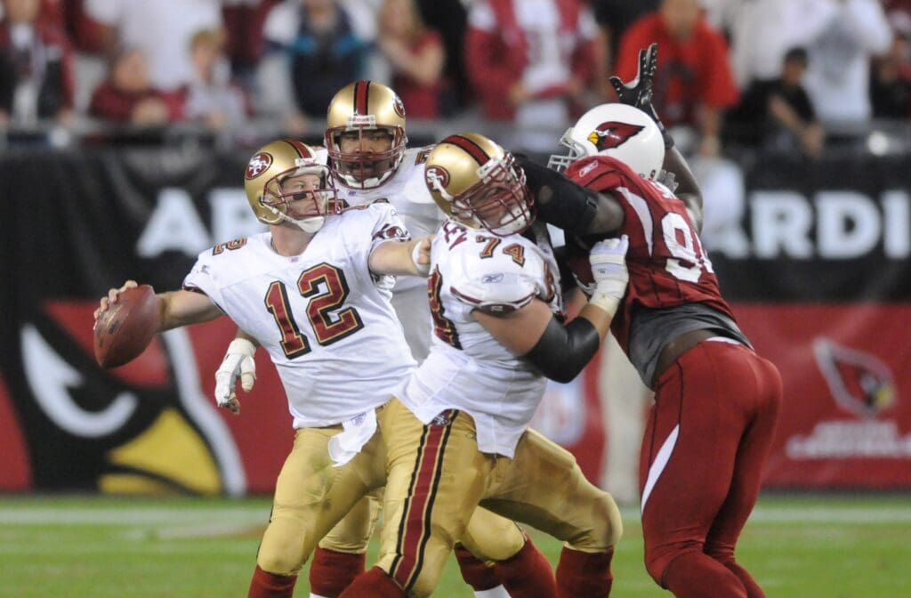 Nov. 25, 2007; Glendale, AZ, USA; San Francisco 49ers quarterback Trent Dilfer (12) throws against the Arizona Cardinals defense in the third quarter at University of Phoenix Stadium. The 49ers defeated the Cardinals 37-31 in overtime.