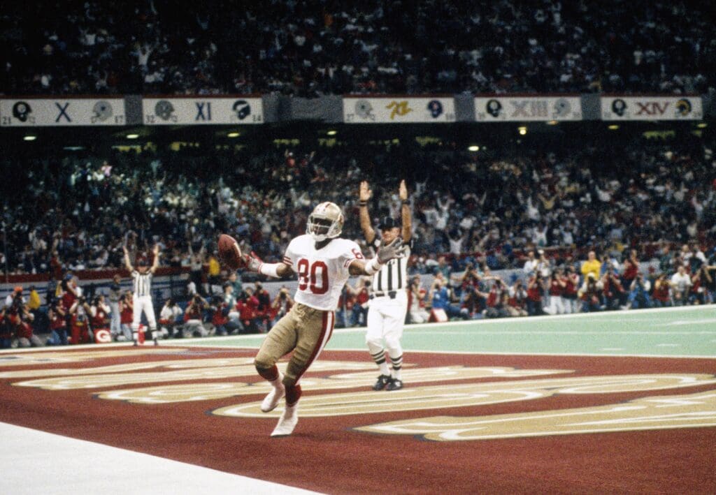 Jan 28, 1990; New Orleans, LA, USA; FILE PHOTO; San Francisco 49ers receiver Jerry Rice (80) scores a touchdown during Super Bowl XXIV against the Denver Broncos at the Louisiana Superdome. The 49ers won 55-10.