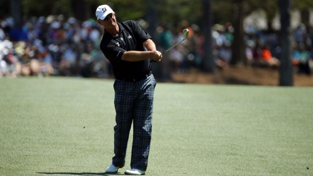 Apr 12, 2014; Augusta, GA, USA; Sandy Lyle hits from the fairway of the 13th hole during the third round of the 2014 The Masters golf tournament at Augusta National Golf Club.